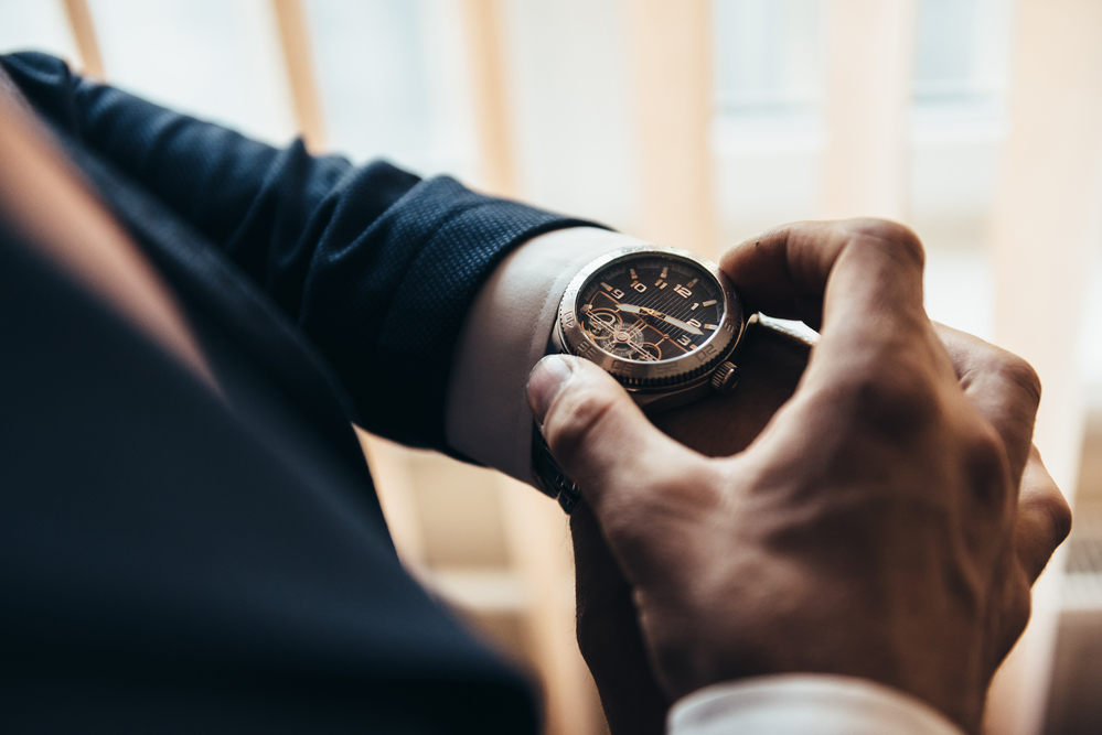 man looking at stylish watch